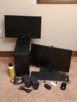 Overview of Asus desktop tower, both monitors, keyboard, mouse, speakers, hubs and webcam on carpet