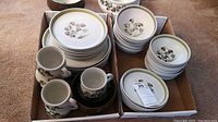 Full set of plates, bowls, cups and saucers arranged in two boxes showing floral patterned denby dinnerware.