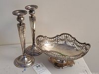 Overall view of two candlesticks and pedestal bowl on table