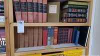 Wide view of two shelves of vintage books showing the full set of Winston Churchill books, other classic titles, and the hourglass timer on the side.