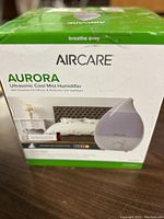 Front view of the Aircare Aurora humidifier original box showing product image, name, and key features.
