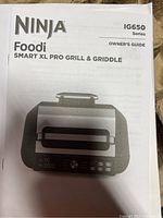 Owner's guide for Ninja Foodi Smart XL Pro Grill & Griddle IG650 Series showing front view of appliance.