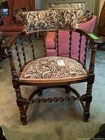 Front angled view of vintage barley twist wooden occasional chair showing floral upholstery on seat and backrest.