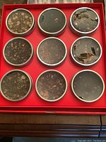 Photo of 9 round tins of various tea blends in a red box from David's Tea festive collection.
