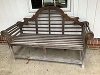 Front view of full teak bench showing decorative arched lattice back and slatted seat