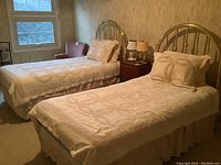 Two fully dressed twin beds side by side in bedroom