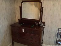 Front view of dresser with attached mirror, showing overall shape and finish