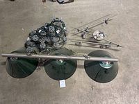 Top view of both ceiling light fixtures showing green glass lampshades, metal rods, and hanging chains spread out on the floor.