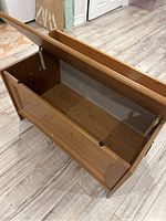 Open bench revealing internal storage compartment, corrugated back panel visible