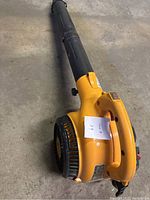 Side view of yellow Poulan Pro leaf blower showing overall shape, blower tube, and handle with paper label marked '24'