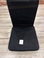 Front view of black cushioned floor meditation chair showing seat and backrest