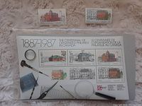 Full view of 6 Canadian stamps commemorating the centennial of organized philately in 1987, arrayed on a card with philatelic tools and descriptive text.