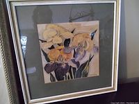 Full view of the framed watercolour artwork showing orchid flowers in mixed soft colors with green leaves, signed D Manning at bottom right.