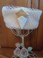 Front and upper angled view of the vintage Anita Pineault hat showing fine netting and pearl applique detail.