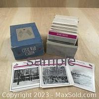 Blue cardboard box labeled 'Civil War Cards' next to numerous collectible cards standing in the box with three cards laid flat in front showing images of soldiers and buildings.