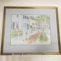 Framed serigraph print showing a pastel-colored street scene in Nantucket with houses and white picket fences.