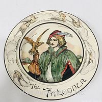 Top view of Royal Doulton portrait plate featuring The Falconer with border of flying storks