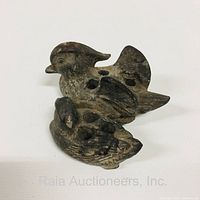 Top-angle photo showing two cast metal flower frogs shaped like wood ducks, highlighting the shape and details of the ducks.