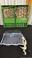 Two green cases with Green Lee drill bits wrapped in paper, sizes clearly visible. Below is a canvas roll of Mayhew pin punches.