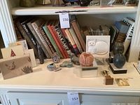 Wide view of shelving with books and decorative objects front row