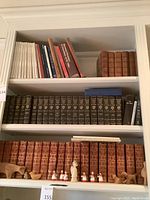 Three shelves with books and decorative pieces