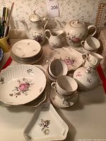 Full group shot showing all porcelain pieces arranged on table.