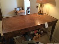 Front and top view of desk showing overall form, drawers, and legs with casters