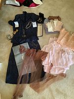 Overview of midnight blue jacket and skirt with hosiery, jewelry, gloves, sleepwear and stole