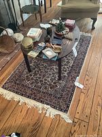 Overview of the rug under a coffee table on hardwood floor