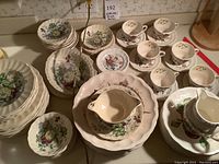 Overall view of stacked dinner plates, bowls, teacups and saucers