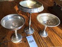 Three sterling silver pedestal cups arranged together