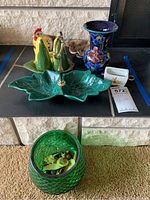 Vintage salt and pepper shakers shaped like a rooster and green pepper, green leaf-shaped ceramic tray with brass-tone handle, floral painted ceramic vase, and green textured glass candy dish with lid