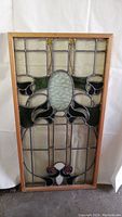 Full front view of rectangular stained glass panel in wood frame against white backdrop