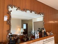 Full front view of the mirror leaning against wood-paneled wall