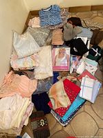 Full lot laid out showing various pajamas, knit hats, gloves, scarves, slippers, and undergarments including camisoles and slips, mostly new with tags.