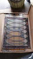 Full view of large stained glass window with oval lead pattern and textured clear glass panels