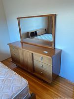 Front view of nine-drawer dresser with attached rectangular mirror