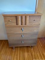 Full front view of the four-drawer dresser showing top and lower handles