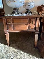 Front view of one Kroehler wooden side table with drawer closed, showing brass handles and paneled design