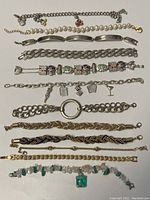 Full overview showing all 12 bracelets arranged side by side, showcasing variety including silver-toned, gold-toned, beaded, and charm designs.