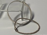 The hammered bangle and beaded stretch bracelet together, showing size and design