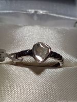 Close-up photo of the ring showing the triangular rose cut Polki diamond bezel set in a twisted sterling silver band with rhodium plating.