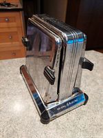 Vintage General Electric chrome two piece side loading toaster, showing front and side profile with logos and handles.