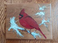 Front-facing clear photo of the wooden plaque featuring the hand-painted cardinal and snowy branches artwork, showing the item's condition and details.