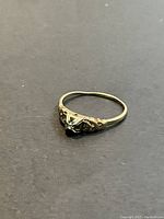 Top-front view of the ring showing all three diamonds and filigree setting