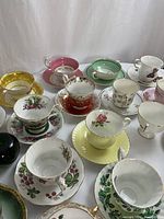 Close-up view of front-row sets: strawberry vine pattern, yellow rose motif, green ivy pattern