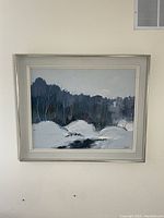 Frontal view of framed oil painting showing winter woodland scene