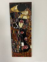 Full view of the rectangular ceramic tile showing the entire raised depiction of 'The Kiss' artwork.