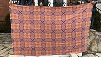 Full view of blanket held outdoors to show overall pattern and size
