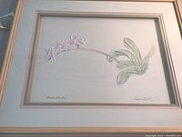 Full view of the framed pastel orchid painting showing the entire artwork, frame, and artist signature.